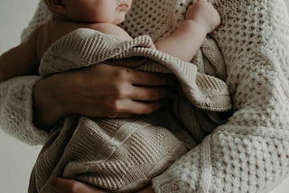 Close up shot of a womand holding a baby.