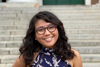 Isabel Yap, author of Never Have I Ever, standing in front of a building at Harvard.