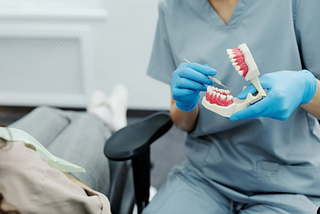 A dentist using a dental scaler