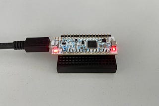 A Nucleo-32 development board on a small breadboard and connected to USB