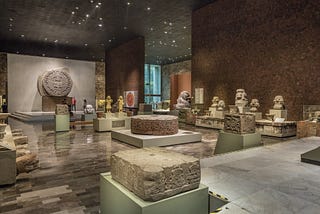 Exposition of various ancient aztec sculptures made of stone, including the Piedra del Sol (Stone of the Sun)