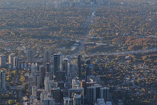 A shot from the North end of Toronto looking south. You can see the both literal and figurative division of Toronto. There are high-rise buildings at the bottom of the page, and a chunk of mid-rise multi-unit places.