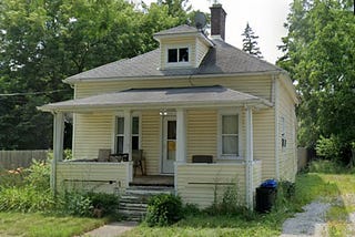 The haunted bungalow looks innocuous with her cheerful new siding. Image ©Grace Ombry