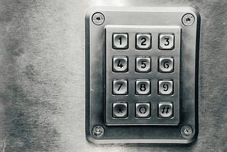 Keypad on silver metal door or wall.