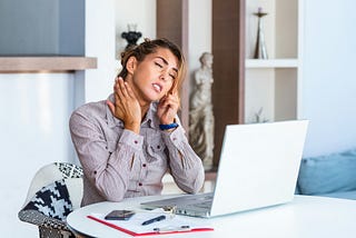 A woman at a computer looking upset.