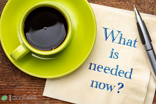 A yellow cup and saucer with coffee sits atop a napkin that has “What is needed now?” typed on it in a blue serif font. This implies that the article relates to how “I need money right now, what should I do?”