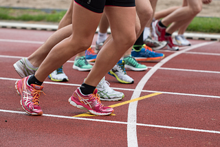 Photo shows runners’ legs ready to start.