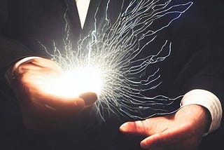 A man holding electricity in his hand representing clean energy.