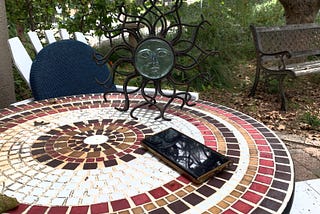 Android phone lying on circular garden table.