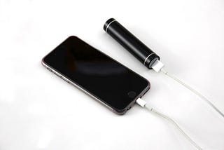 A picture of an iPhone connected to a powerbank.