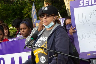 Nicole Brazil speaking at an outdoor rally.