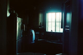 white top mount refrigerator beside white wooden door