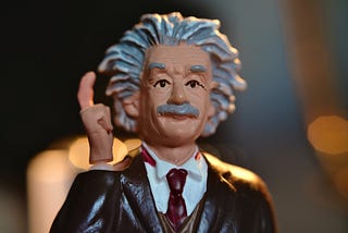 A figure of Albert Einstein in a Eureka! moment