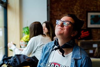 Woman smiling with a mouth full of food