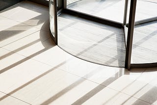 A picture of a large revolving door, like the one you would find in an office building or department store.
