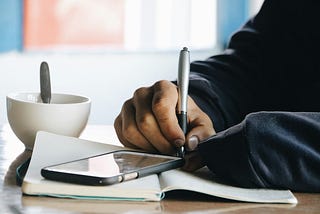 A writer writing in a diary