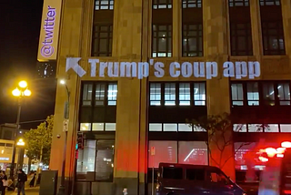 Photo of “Trump’s coup app” projected on Twitter headquarters with an arrow at the Twitter logo