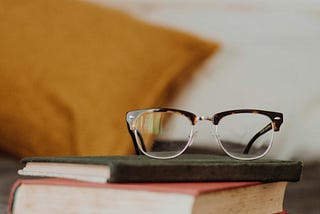 Image of reading glasses with books