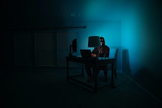 A man on his laptop, working at night.