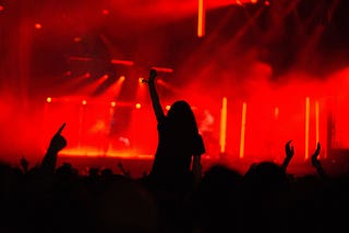 Silhouette of a woman at an electronic show on the shoulders of someone else