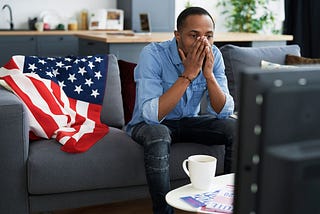 man watching political news on tv