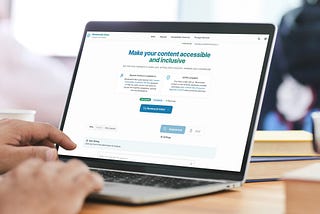 A person working on a laptop displaying the Rembrandt Editor accessibility tool.