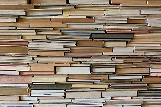 A wall of books piled on top of each other