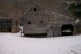 An old barn in the snow.