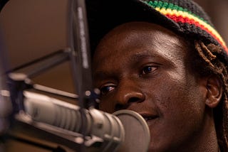 A man talking into a microphone in a studio.