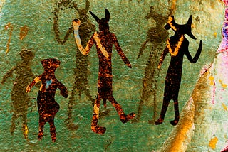 Cave art depicting three humanoid figures. The image has been colorized in surreal golds, greens, oranges and pinks, giving it a mysterious psychedelic look.