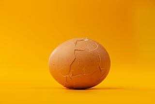 Cracked Egg Shell on Yellow Background