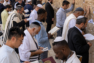 A group of diverse Jewish men at the Western Wall