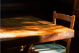 A wooden Dinner Table with chair