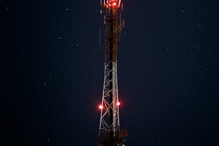 Tower at night with red light signals