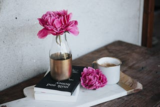 Peonies next to a book | Author Kimberly A. Irwin