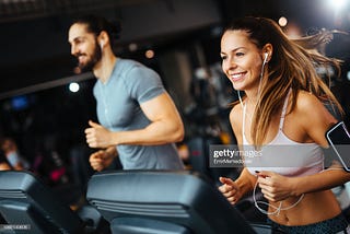 Sporty people running on a treadmill cardio