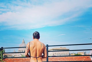 male in front of St Peter’s Cathedral in rome