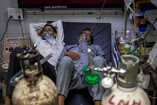 Two COVID patients sharing a single hospital bed