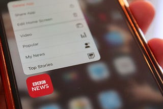 An image of the BBC News app on a cell phone