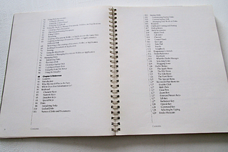 Spiral-bound tech manual opened to Table of Contents.