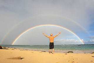 Author stares at ocean and a double rainbow.