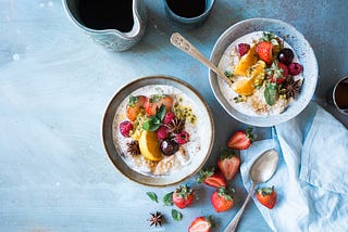 Two bowls containing healthy food sits on the table