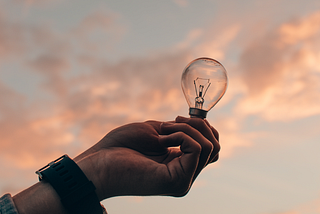 Representation of ideas — Hand holding a light bulb