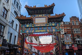 Ornate Chinese gate with red lanterns in street