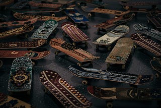 A photo of Maximum Sensation, a sculpture of a group of skateboards of different colors.