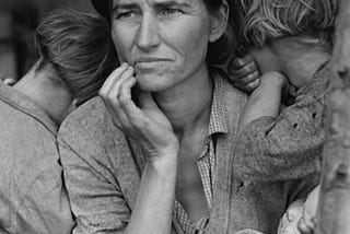 Florence Owens Thompson, a farm worker hindered by conditions during the Great Depression. Two of her children huddle around her for warmth and protection. Thompson holds her baby. | The photograph is titled “Migrant Mother” — it was taken by Dorothea Lange. It is part of the Franklin D. Roosevelt Library Public Domain Photographs (NAID 195301), Wiki Commons.