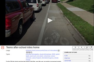 screenshot of video clip showing bumper to bumper cars waiting to pick up students and take them home, work, or another destination