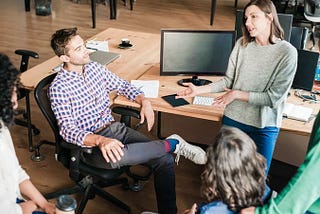 Casually dressed team members talking in an office