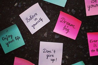 An image that contains papers with motivational quotes written on them