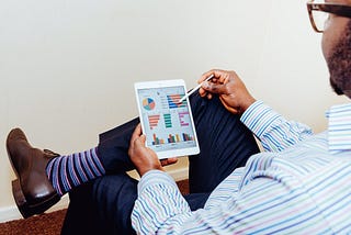 Man viewing chart on tablet